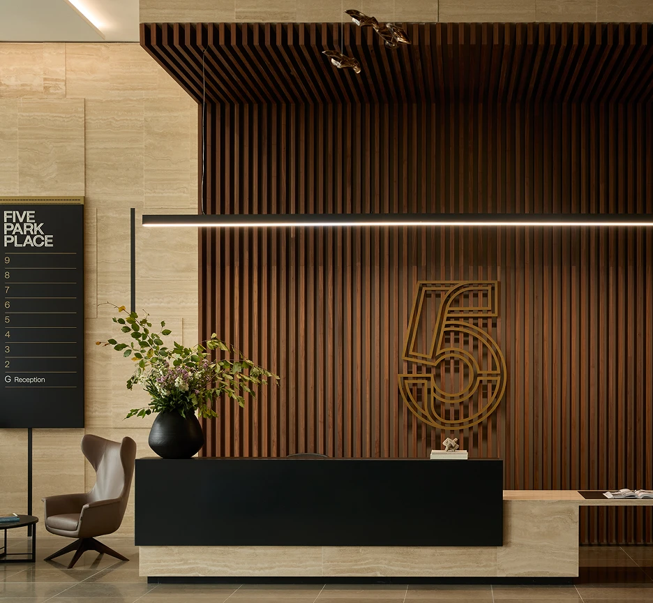 Elegant reception of Five Park Place with wooden backdrop with a large gold 5 numeral attached.