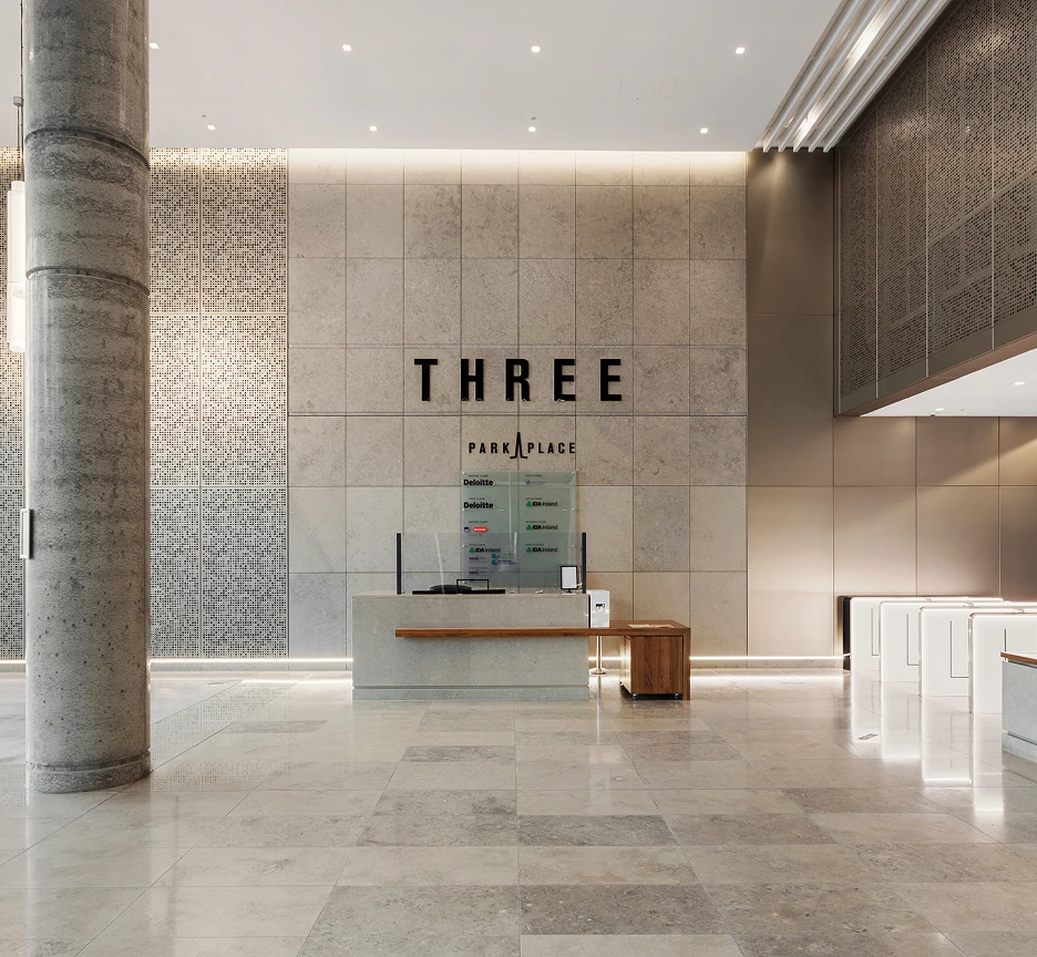 High celling reception and lobby area with grey marble floor, walls and pillars