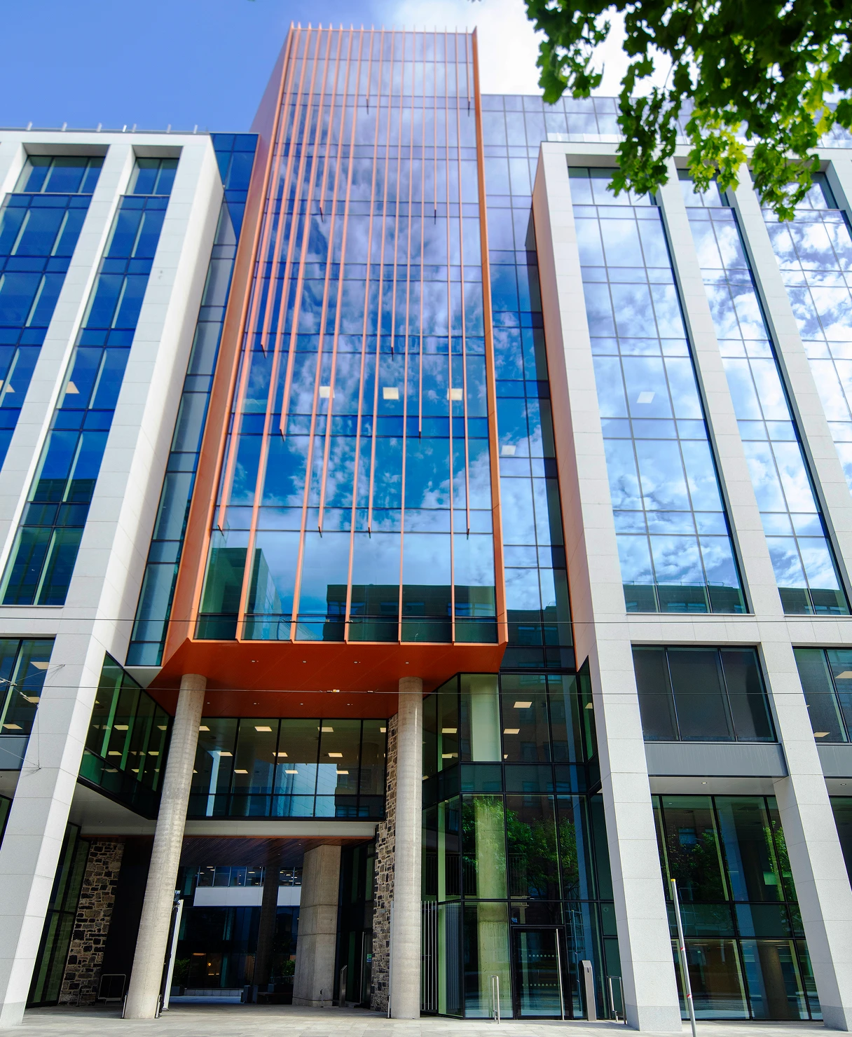 Park Place outdoor archway surrounded by building windows and blue sky.