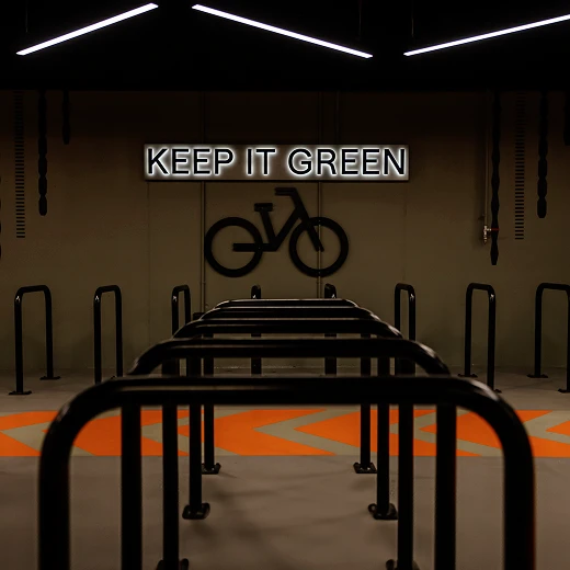 Underground bike rails with wall sign saying 'Keep It Green'.