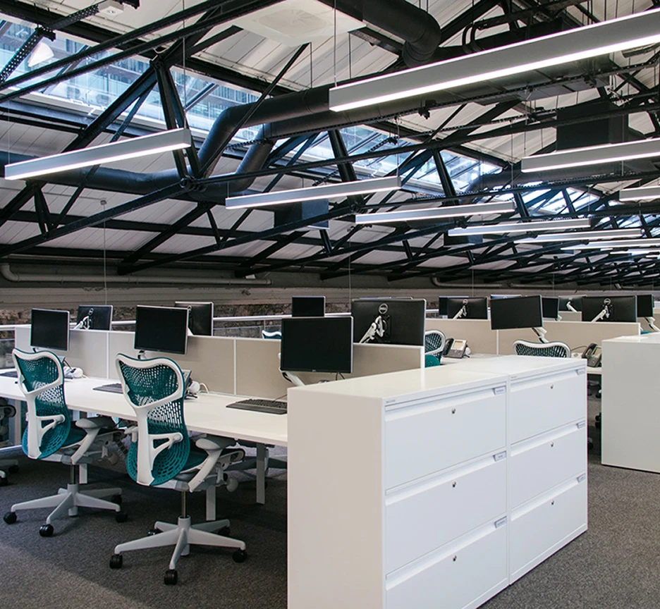 Workstations with revealed roof beams.