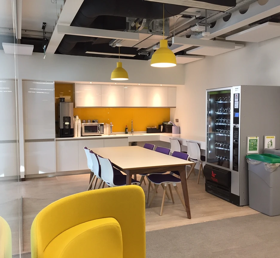 Kitchen area with yellow seats.