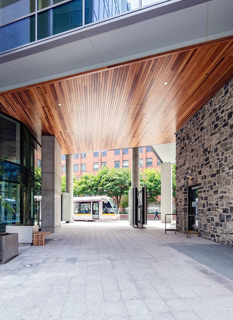 Park Place outdoor corridor with the Luas tram passing in the background.