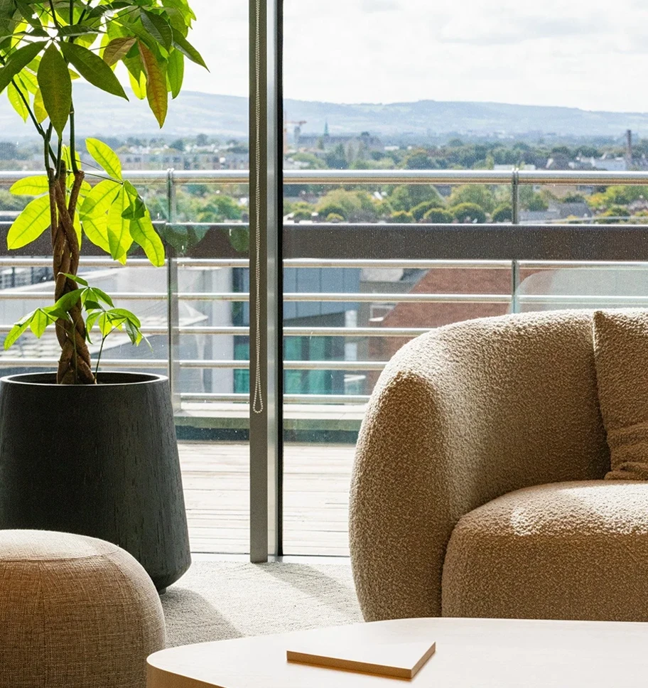 Closeup of chair and planet with a window view over Dublin city.