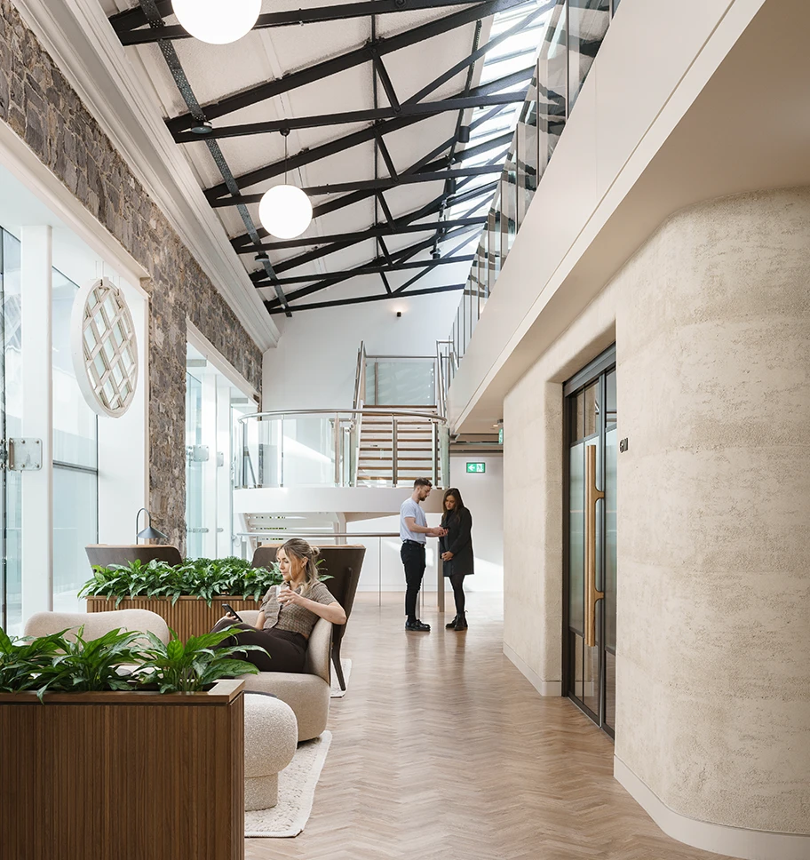 Well lit hallway with 3 members of staff in the space.